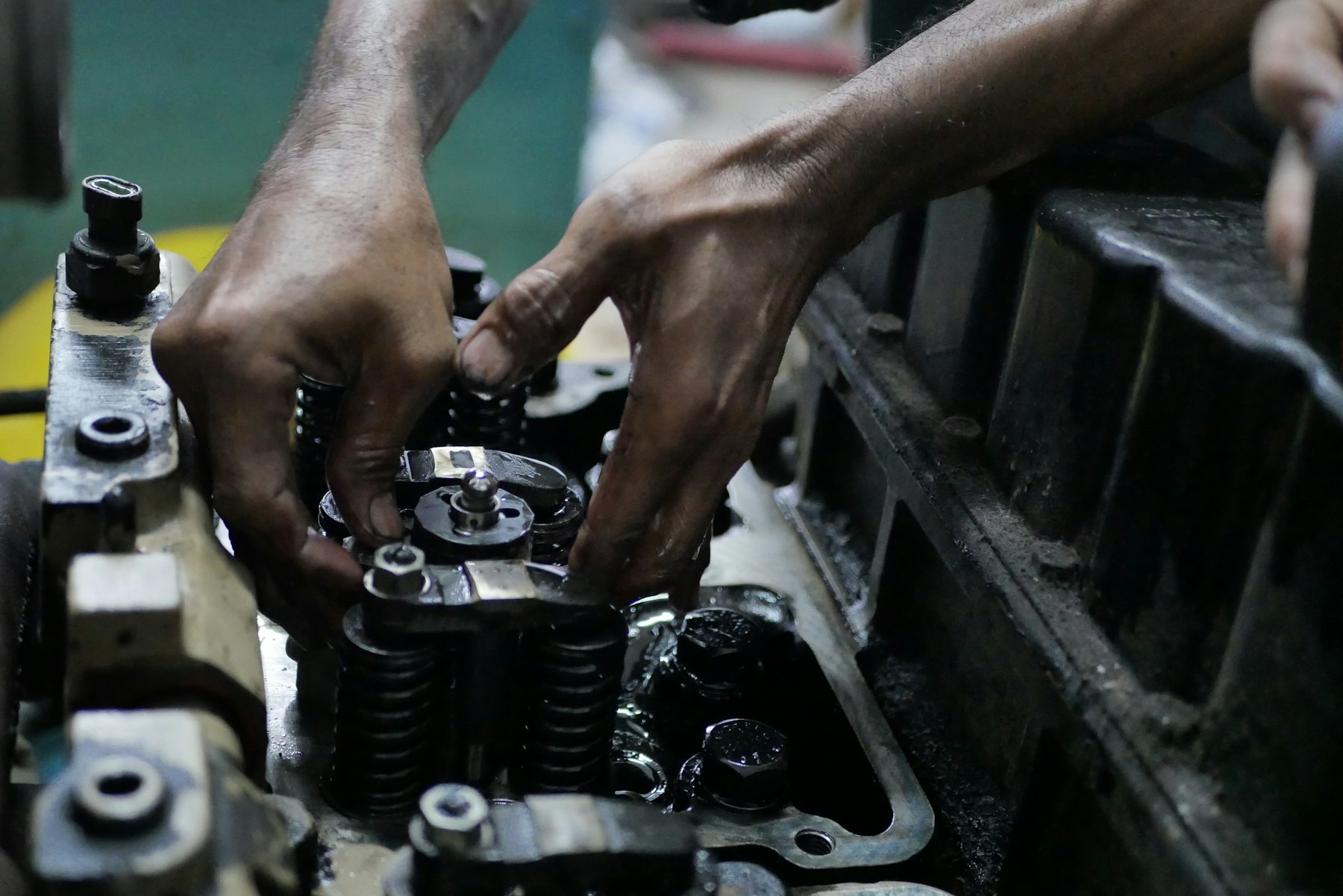 Technician rebuilding engine components