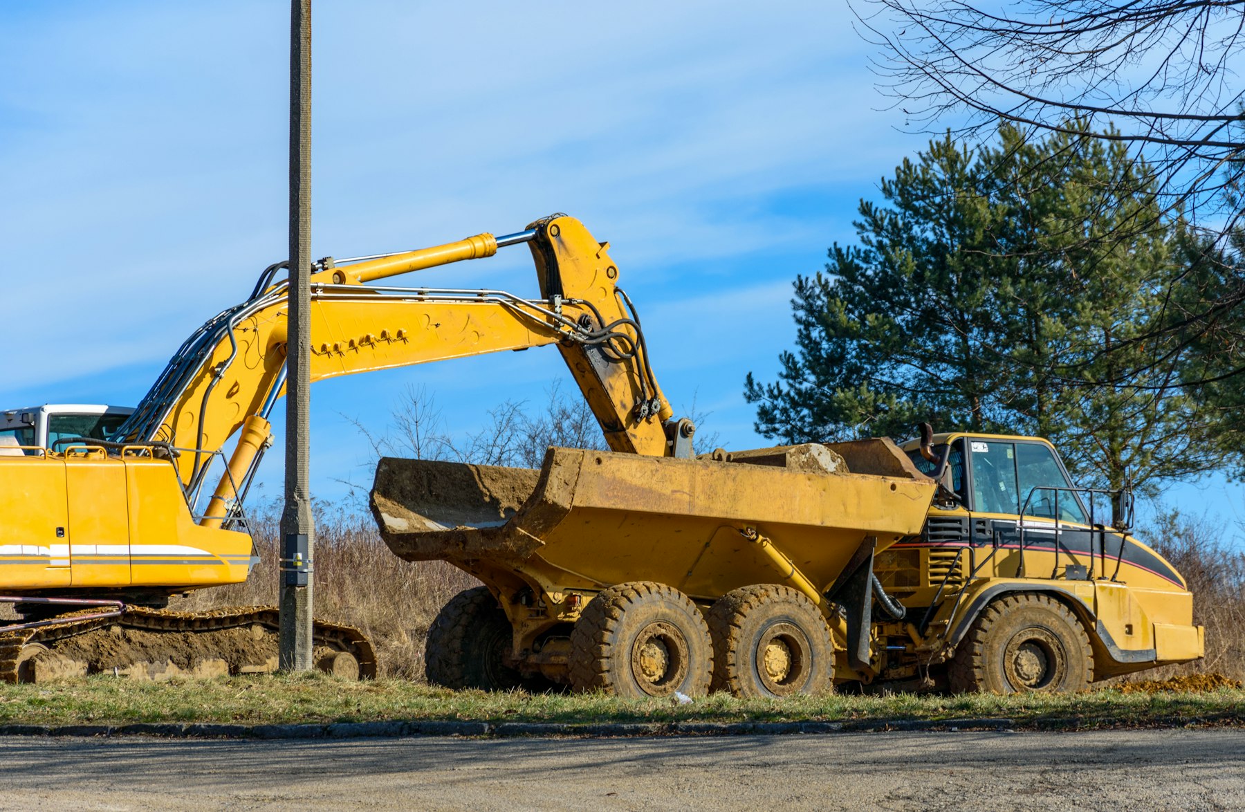 Excavator loading an articulated dump truck
