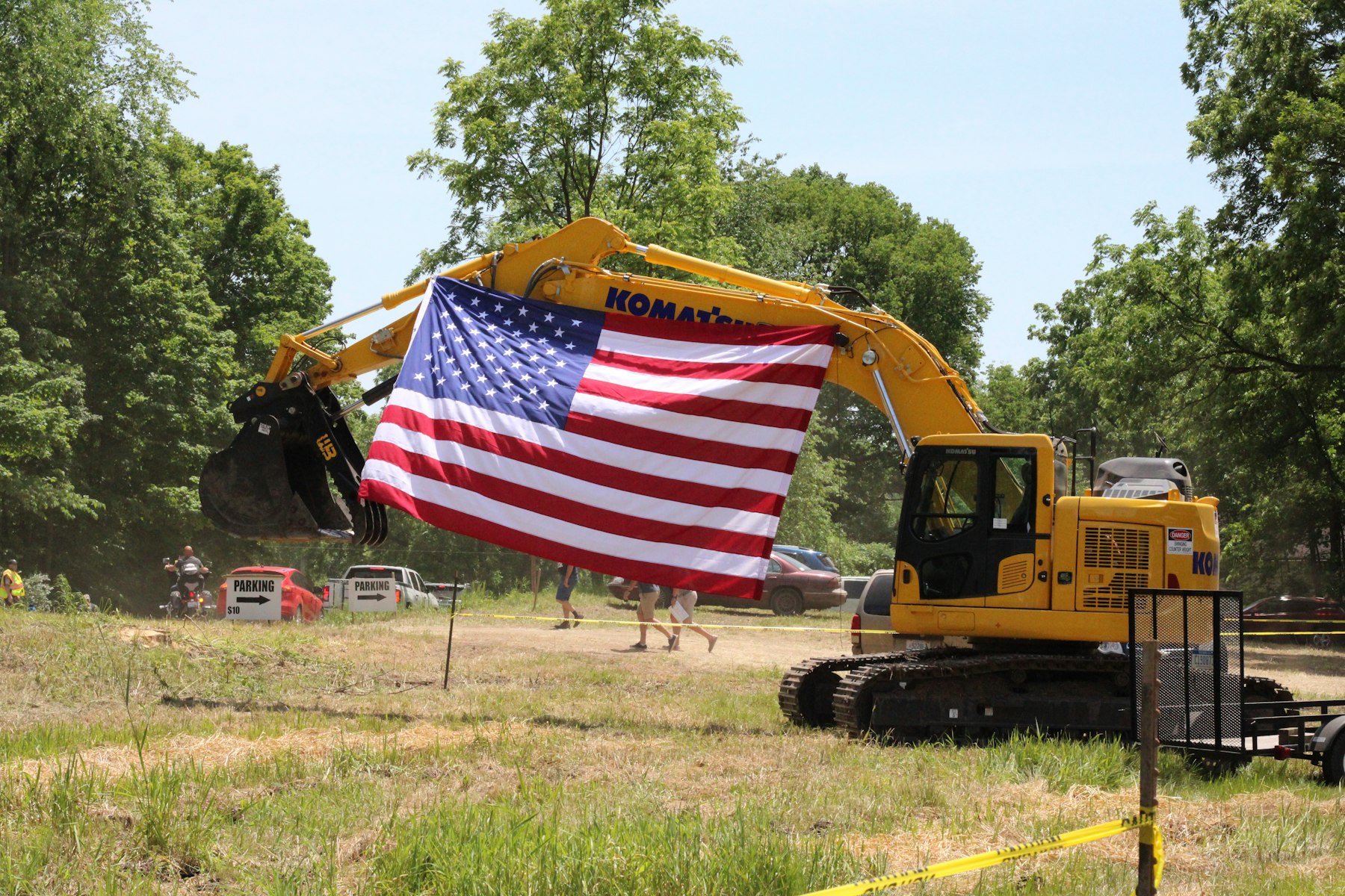 Excavator flying an American flag on a job site